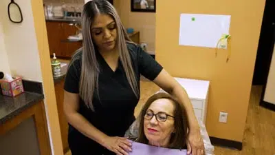 dental assistant prepping patient for an emergency dentistry procedure